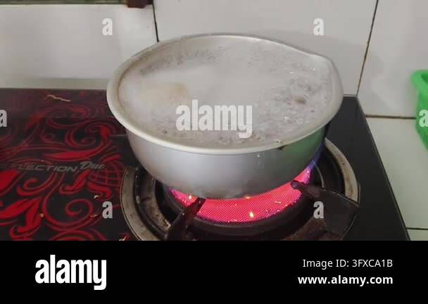 Boiling liquid in a metal pot on a red hot electric stove Stock Video ...