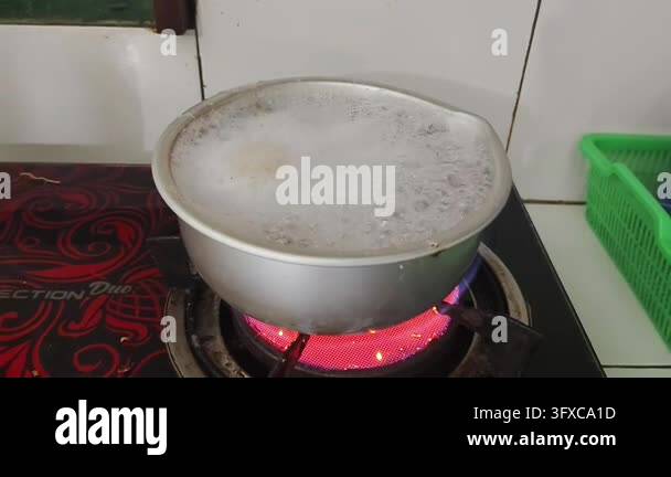 Boiling liquid in a metal pot on a red hot electric stove Stock Video ...