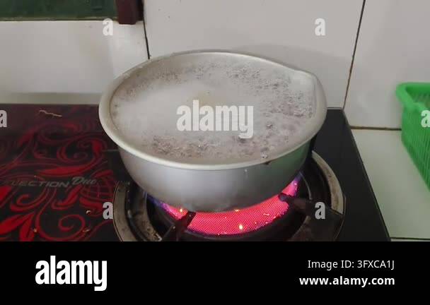 Boiling liquid in a metal pot on a red hot electric stove Stock Video ...