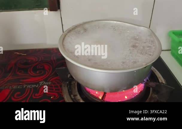 Boiling liquid in a metal pot on a red hot electric stove Stock Video ...