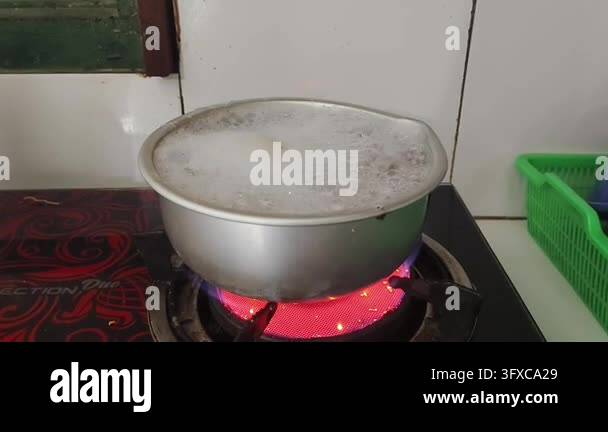 Boiling liquid in a metal pot on a red hot electric stove Stock Video ...