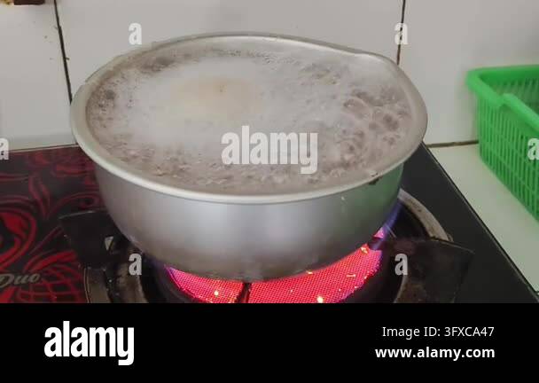 Boiling liquid in a metal pot on a red hot electric stove Stock Video ...