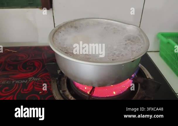 Boiling liquid in a metal pot on a red hot electric stove Stock Video ...