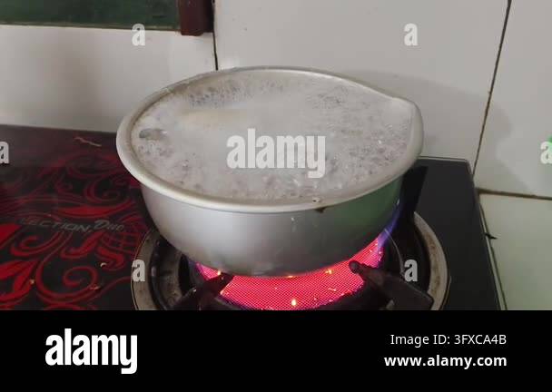 Boiling liquid in a metal pot on a red hot electric stove Stock Video ...