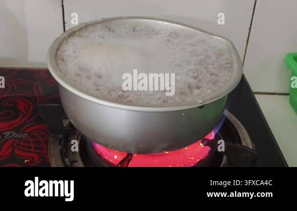 Boiling liquid in a metal pot on a red hot electric stove Stock Video ...