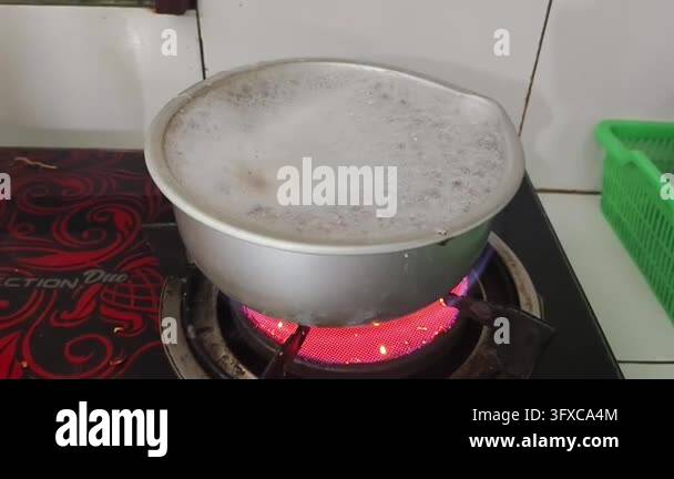 Boiling liquid in a metal pot on a red hot electric stove Stock Video ...