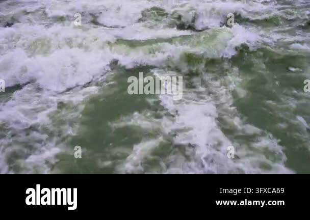 Water Flow Dynamic Shot A Close-up View of Turbulent River Rapids with White Foam and Greenish ...