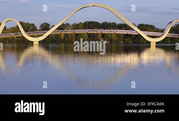 Panoramic view of futuristic Wave pedestrian bridge in Natalka park ...