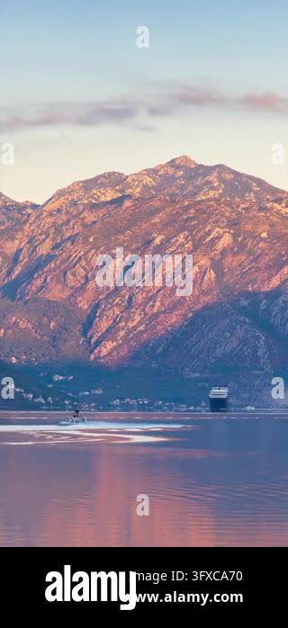 Sunset Time Frame Cruise ship sailing into the calm waters of the Bay of Kotor in ...