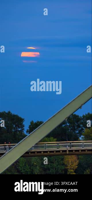 Vertical video of full glowing moon rising behind clouds above Wave ...