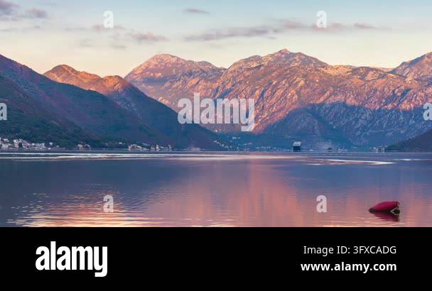 Sunset Time Frame Cruise ship sailing into the calm waters of the Bay of Kotor in ...