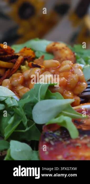 Rustic Asia Bean sandwich plate is arranged with baked beans on bread while fork ...