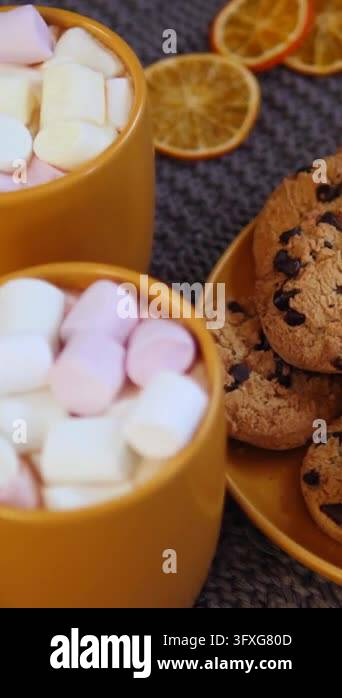 Warm still life of marshmallow cups beside cookie plates, creating ...