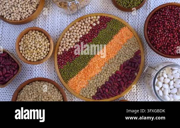 Red Beans Cooked Assorted pulses rest in rustic bowls and clear jars across textured ...