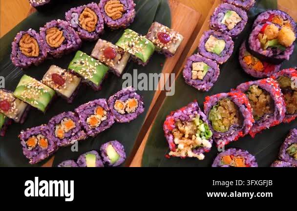 Yo Sushi Rice Sushi rolls arranged on serving trays present colorful assorted sushi ...