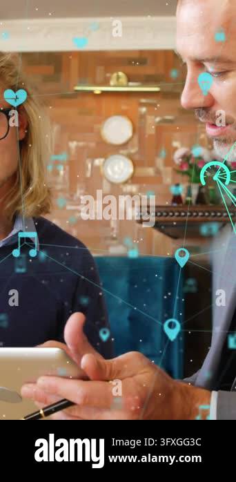 Animation of globes with icons over caucasian business people in office ...
