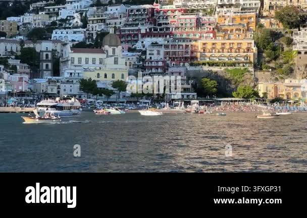 Beatiful Italian Model Thyrenian Sea and row of bright umbrellas on beach of Positano - famous ...
