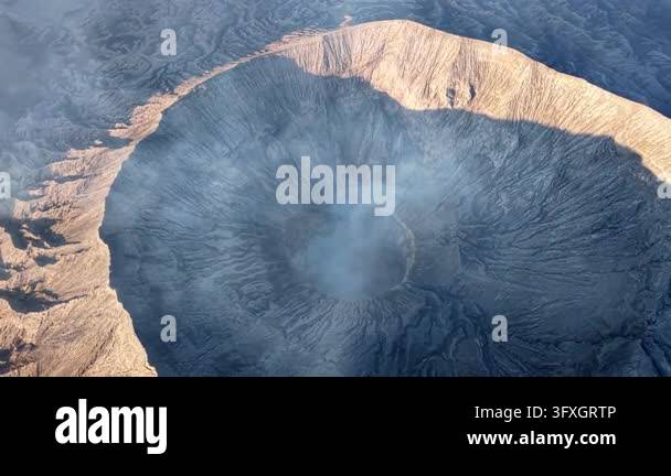 Dramatic Aerial view of Mount Bromo crater rim with rising steam and ...