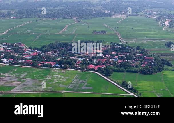 Aerial view shows village nestled in rice fields Stock Video Footage ...
