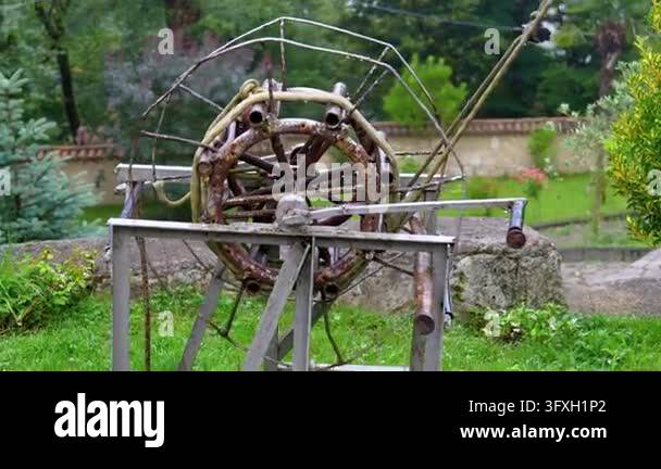 Team Wheel Examples Unique old rusty metal kinetic sculpture with a central wheel and ...