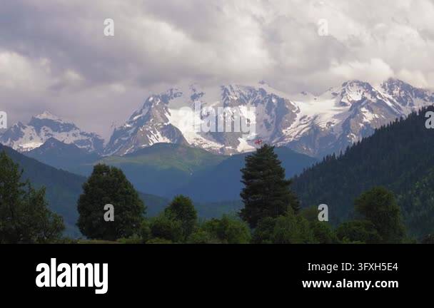 Snowing In Georgia Stunning panoramic view of the snow-capped caucasus mountains in ...
