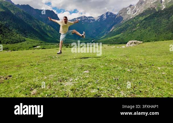 Happy young man dancing, jumping and celebrating life with joy in a ...