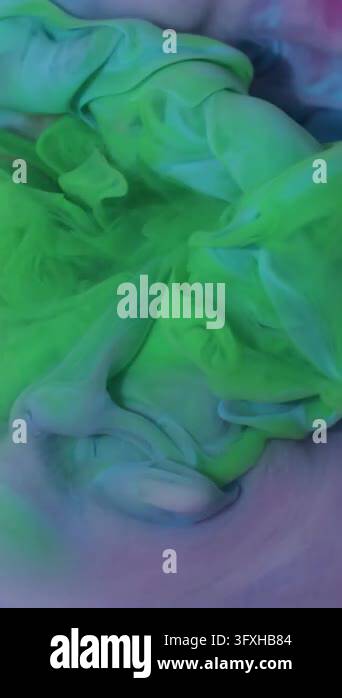 Vertical video. Cloud blend. Ink background. Defocused green blue pink ...