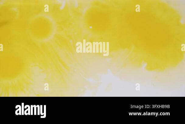 Ink liquid. Splatter yellow water. Defocused white color flow bubbles ...
