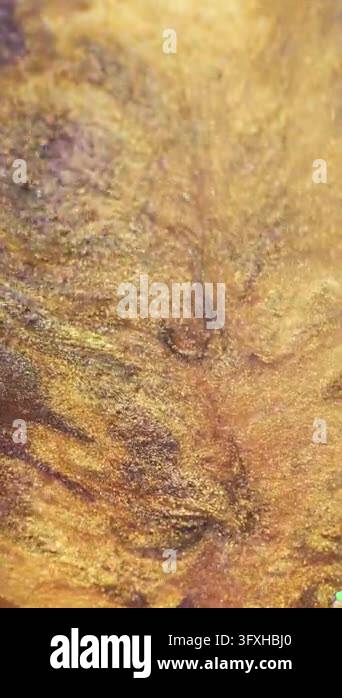 Vertical video. Shiny spatter art. Golden wave. Defocused yellow purple ...