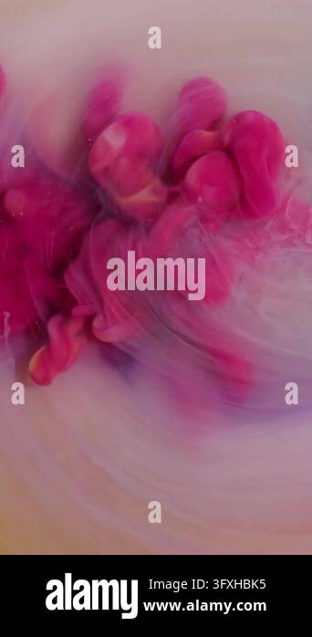 Vertical video. Ink drop. Cloud mix. Defocused yellow pink purple color ...