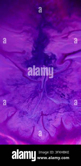 Vertical video. Splatter cube. Neon ink flowing. Defocused purple pink ...
