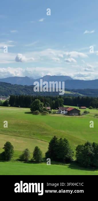 Rural idyll in the foothills, houses on green slopes. Picturesque ...