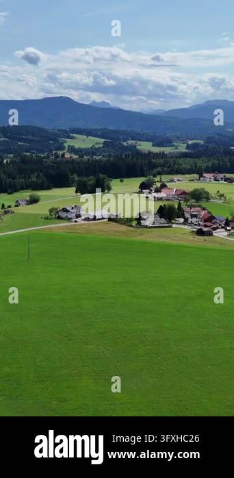 Rural idyll in the foothills, houses on green slopes. Picturesque ...