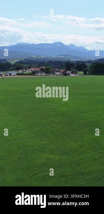 Picturesque alpine farm amidst the green hills of Europe. Panoramic ...