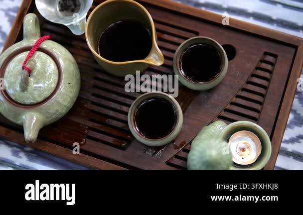 Traditional Tea Pt Tea ceremony arrangement features green ceramic teapot, pitcher and ...