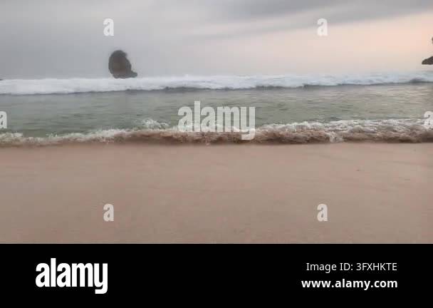 A dynamic, low-angle shot on a sandy beach, capturing fast-moving ...