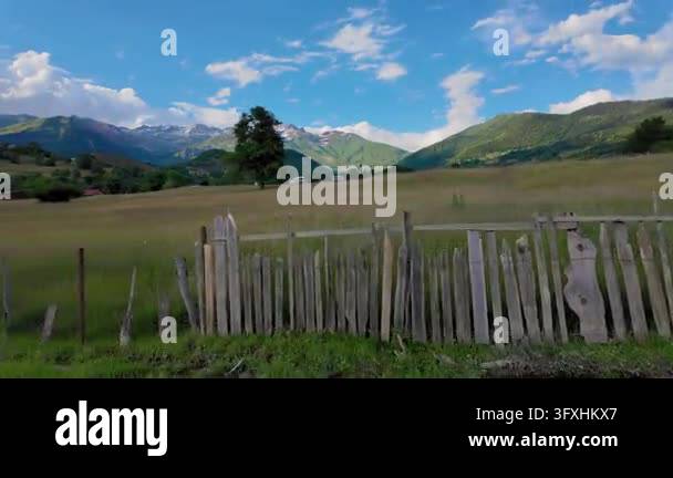 Snowing In Georgia Idyllic summer landscape of Georgian rural village with rustic wooden ...