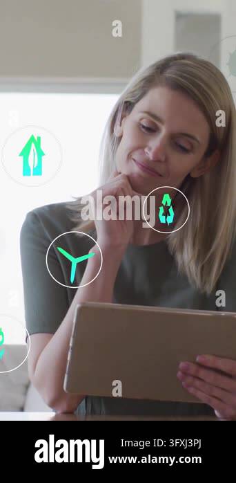 Vertical video: Woman holding tablet, tablet showing eco icons floating ...