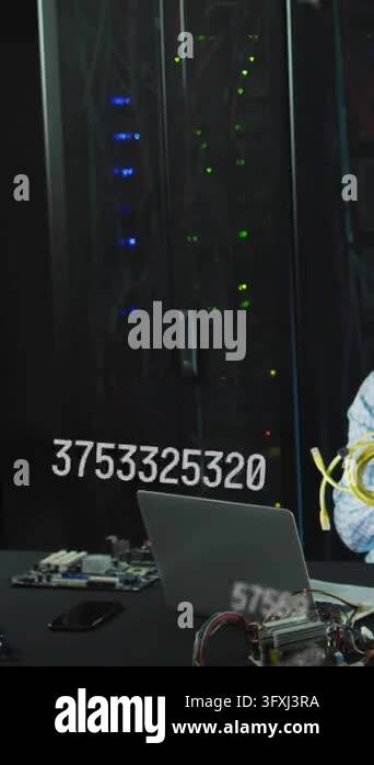 Vertical video: Number overlay appearing, tech holding yellow cords ...