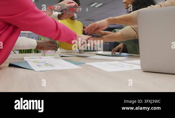 Marketers reviewing data leaning and stacking hands on table, sparking ...