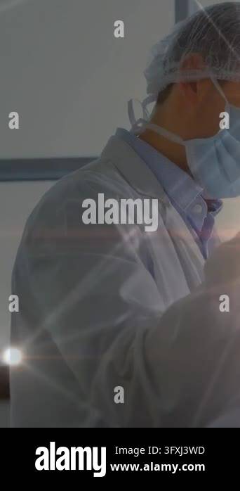 Vertical video: Lab tech raising arm, checking panel, animated overlay ...