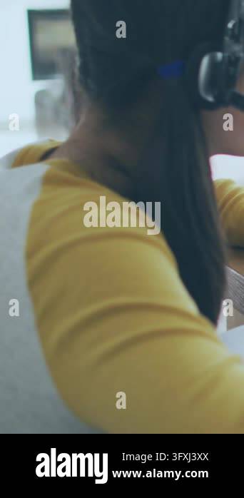 Vertical video: Child at desk, system starting charts overlaying scene ...