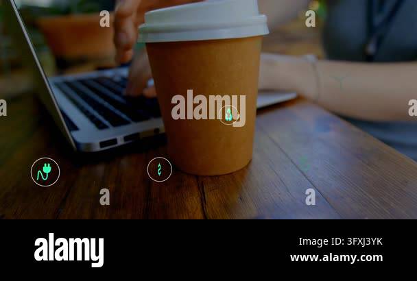 Woman typing on laptop, green icons multiplying around cup, right hand ...