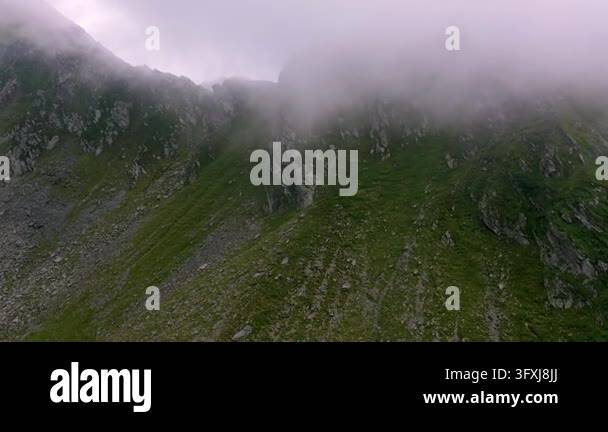 Sc Ree Sloipe Dense fog envelops a rocky mountain ridge in the Carpathians near ...