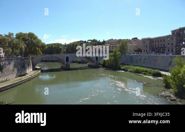 The ancient Ponte Sisto bridge crossing the Tiber river on a sunny day ...