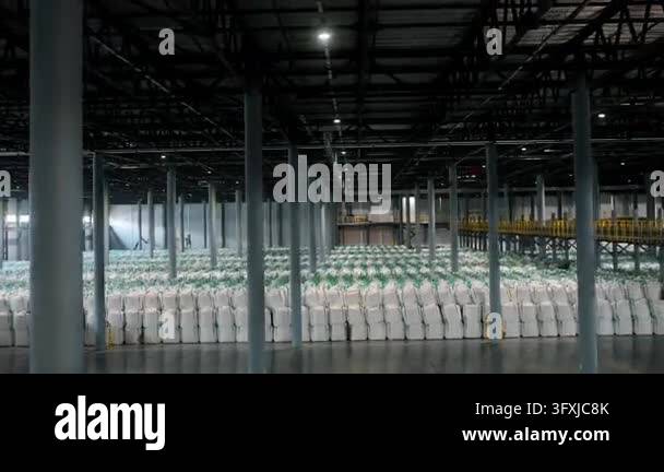 Three Large Warehouse Vector Large industrial warehouse filled with rows of stacked bulk storage ...