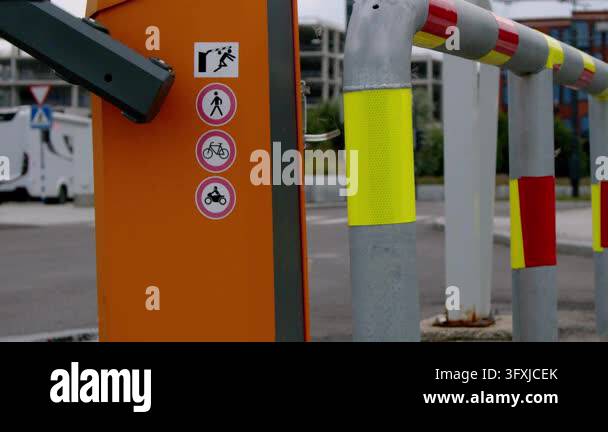 Static close-up of an automated parking barrier gate with reflective ...