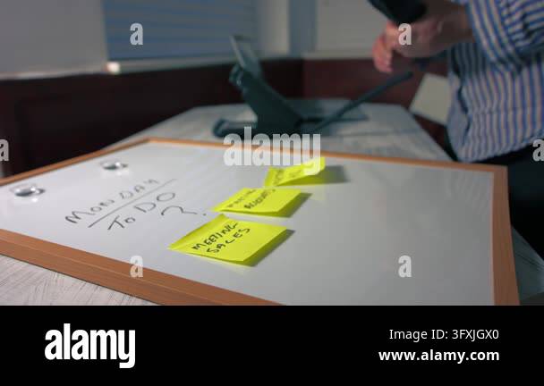 Ohine Using Background Monday morning schedule on whiteboard with woman using phone in ...