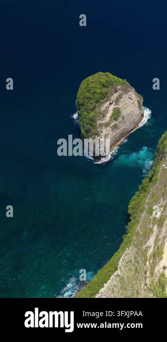 An overhead drone shot glides over the iconic dinosaur-shaped cliff and ...