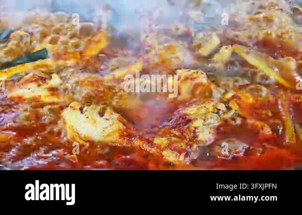 Close up of spicy korean braised chicken stew boiling in a large ...